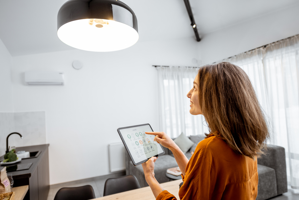 Woman Controlling Lighting with Tablet