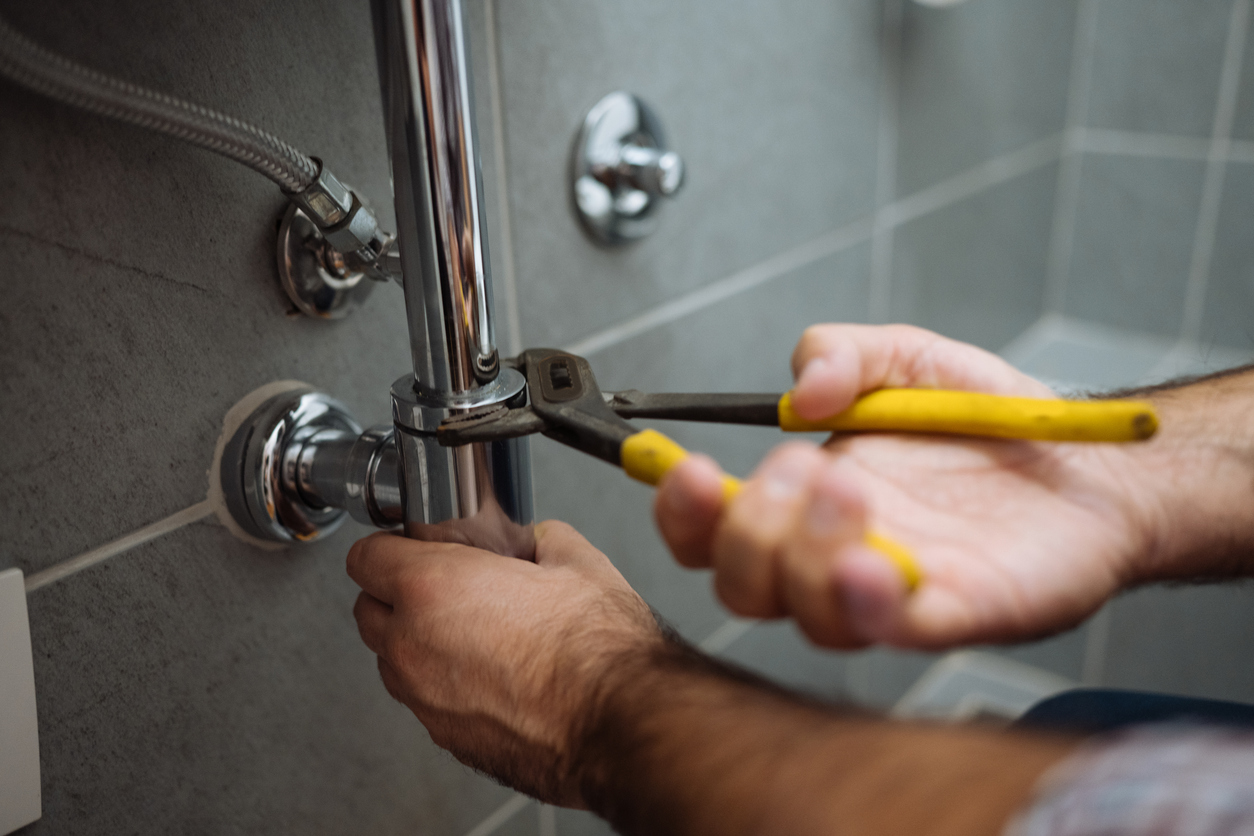 Plumber repairs bathroom sinks