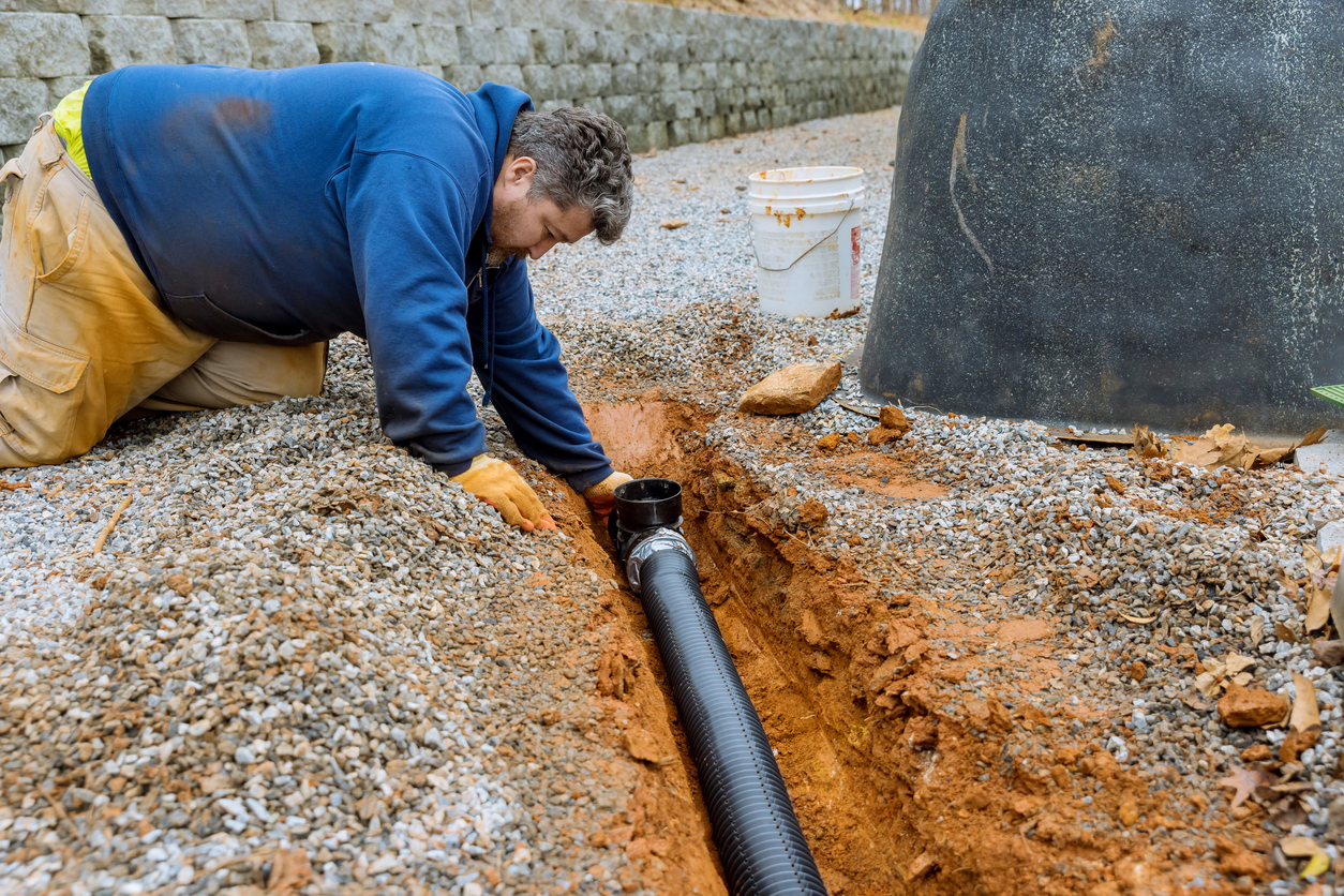 Plumber assembing drainage pipe for sewer line repair